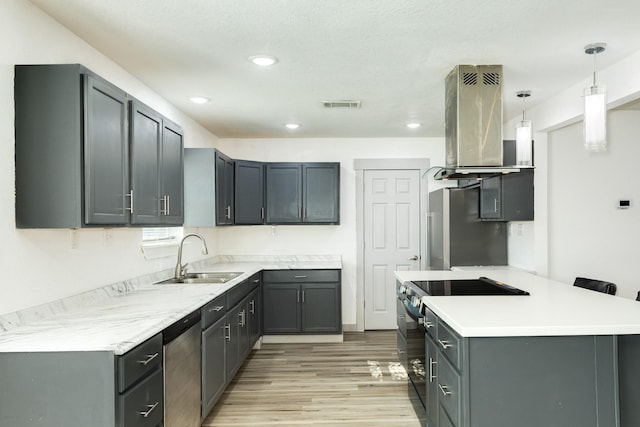 kitchen with sink, a kitchen breakfast bar, ventilation hood, pendant lighting, and appliances with stainless steel finishes