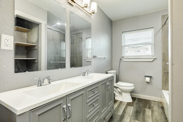 bathroom with vanity, toilet, and wood-type flooring