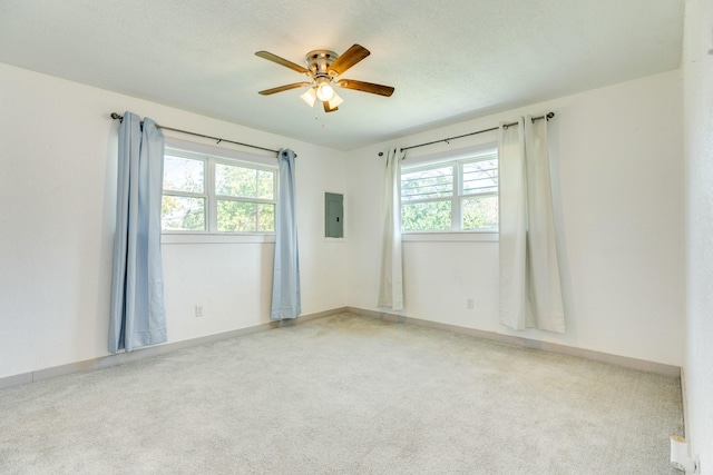 carpeted empty room with electric panel and ceiling fan