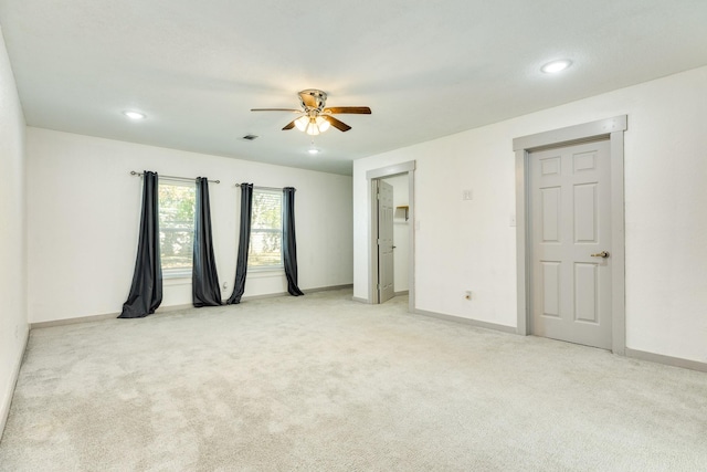 carpeted empty room featuring ceiling fan