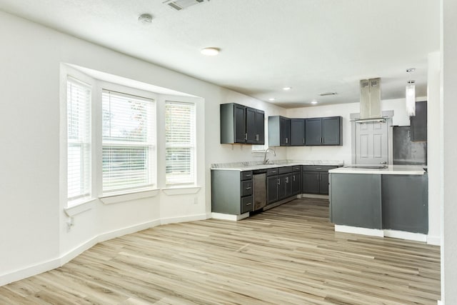 kitchen featuring stainless steel dishwasher, light hardwood / wood-style floors, sink, and island exhaust hood