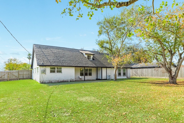 rear view of house with a yard