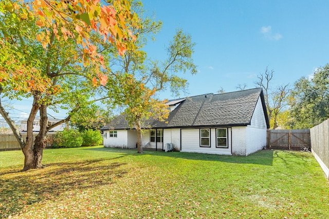 back of property with a yard