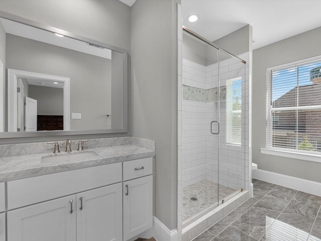 bathroom featuring toilet, vanity, and walk in shower