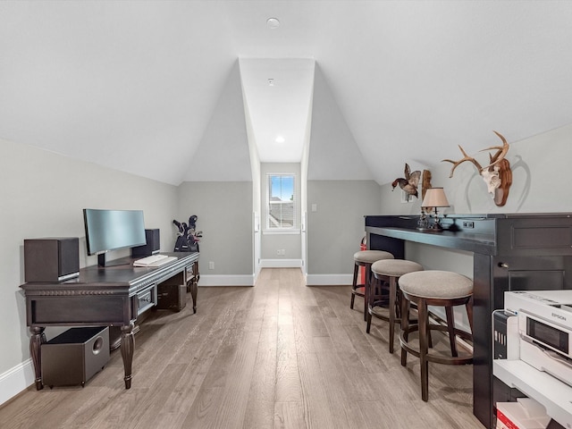 office area featuring light hardwood / wood-style floors and lofted ceiling