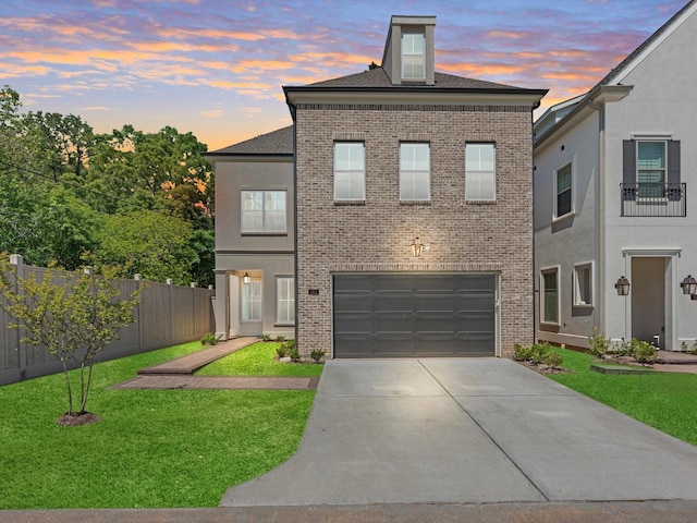 view of front of house featuring a yard and a garage