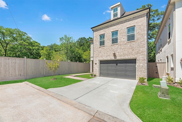 view of front facade featuring a garage and a front lawn