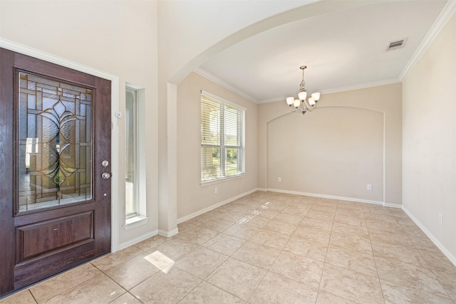 entryway with a chandelier, light tile patterned floors, and ornamental molding