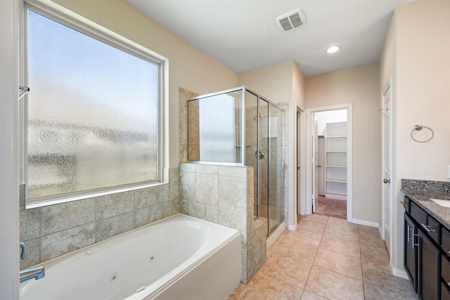 bathroom with tile patterned flooring, vanity, and independent shower and bath