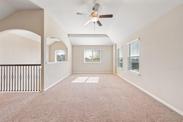 spare room with ceiling fan, light colored carpet, and lofted ceiling