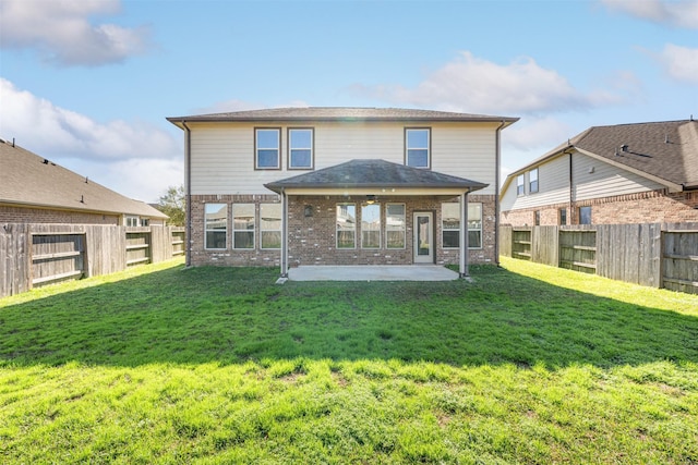 rear view of property featuring a patio area and a lawn