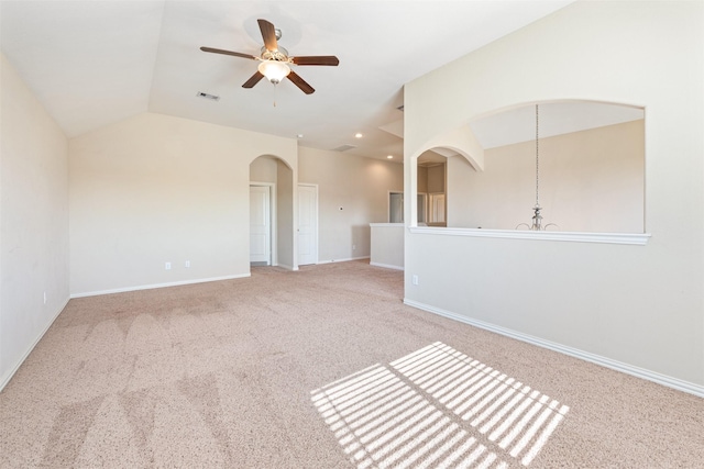 unfurnished room with light carpet, ceiling fan with notable chandelier, and lofted ceiling