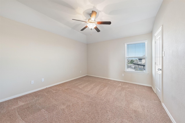 spare room with ceiling fan and carpet