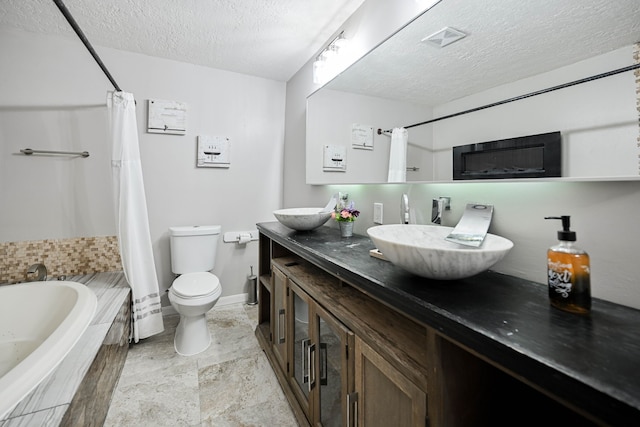 full bathroom with vanity, toilet, a textured ceiling, and shower / tub combo