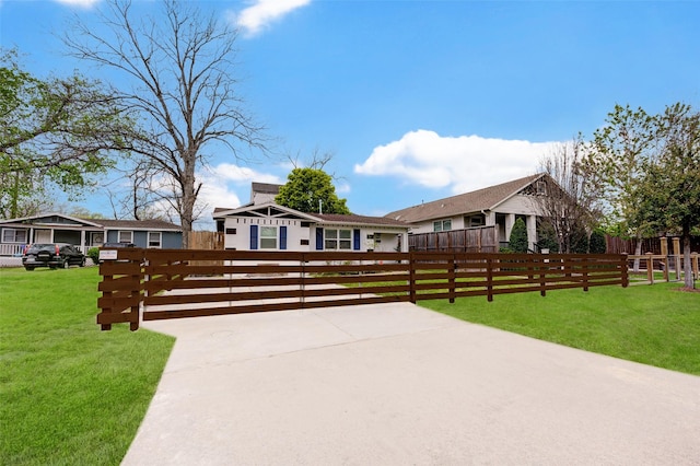 ranch-style home featuring a fenced front yard and a front lawn