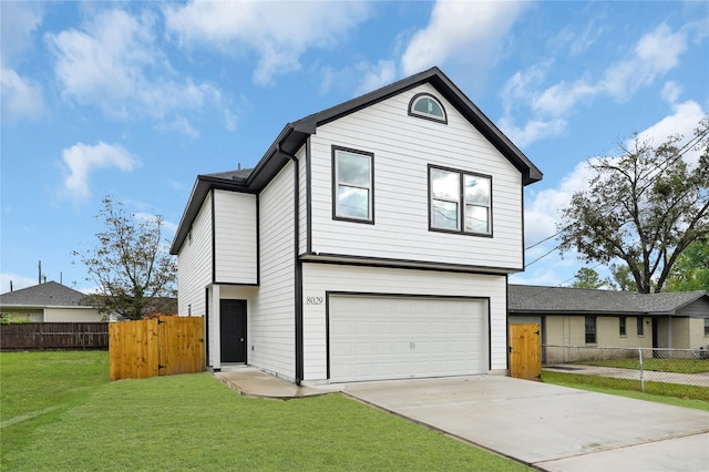 view of front of home with a front yard and a garage