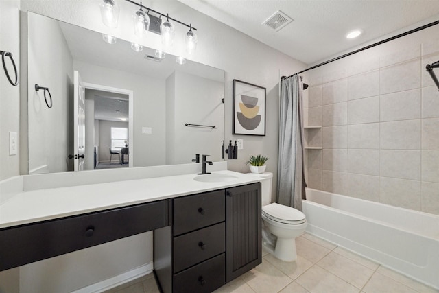 full bathroom featuring tile patterned floors, shower / bath combination with curtain, a textured ceiling, toilet, and vanity