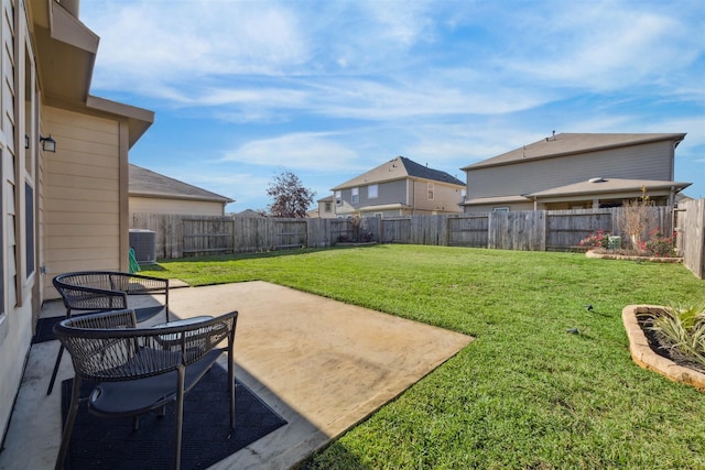 view of yard with central AC unit and a patio