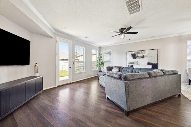 living room featuring a textured ceiling, dark hardwood / wood-style floors, ceiling fan, and ornamental molding