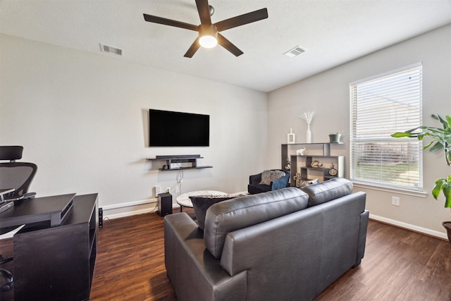 living room featuring plenty of natural light, ceiling fan, and dark hardwood / wood-style flooring