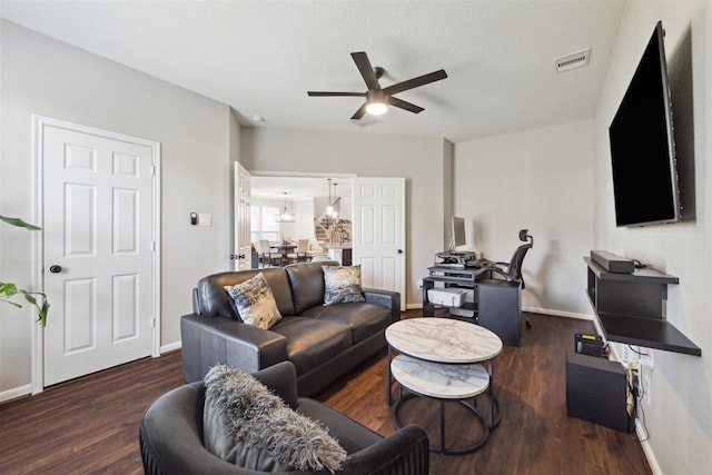 living room with ceiling fan and dark wood-type flooring