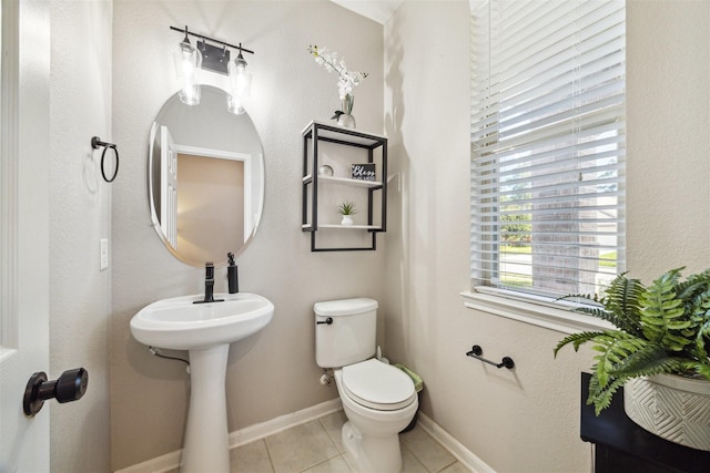 bathroom with tile patterned flooring and toilet