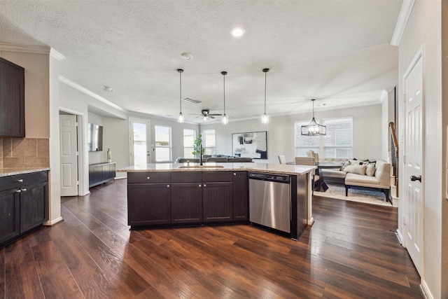 kitchen featuring dark brown cabinets, stainless steel dishwasher, hanging light fixtures, and an island with sink