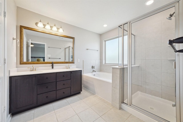 bathroom with tile patterned flooring, vanity, and plus walk in shower