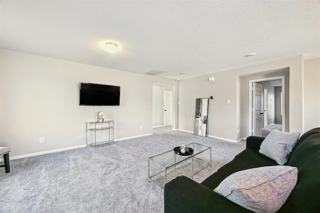 living room featuring carpet floors and a textured ceiling