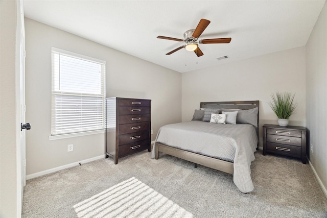 bedroom with ceiling fan and light colored carpet