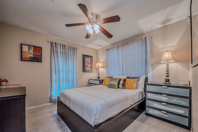 bedroom with ceiling fan and light hardwood / wood-style flooring