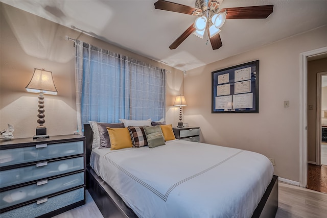 bedroom with ceiling fan and light wood-type flooring