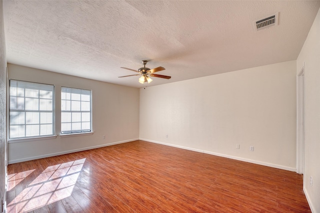 spare room featuring a textured ceiling, hardwood / wood-style flooring, and ceiling fan