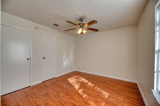 spare room with hardwood / wood-style floors and ceiling fan