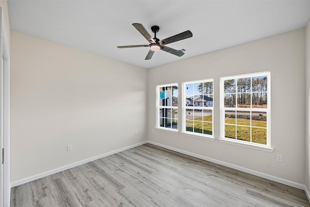 unfurnished room with ceiling fan and light wood-type flooring