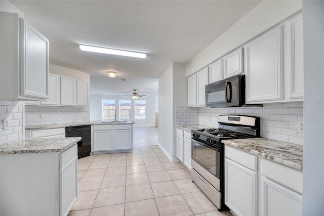 kitchen with kitchen peninsula, ceiling fan, black appliances, white cabinetry, and light tile patterned flooring