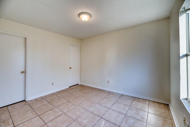 empty room with light tile patterned floors