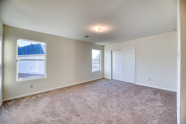 unfurnished bedroom with carpet flooring and a closet