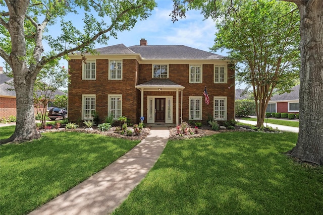 colonial home with a front lawn