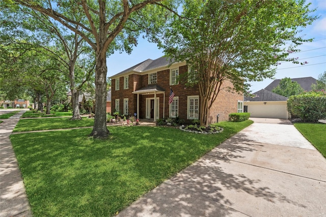 colonial-style house with a garage and a front lawn