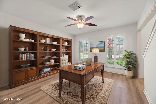 home office featuring ceiling fan and light hardwood / wood-style flooring