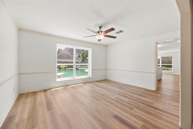 spare room featuring crown molding, ceiling fan, and light wood-type flooring