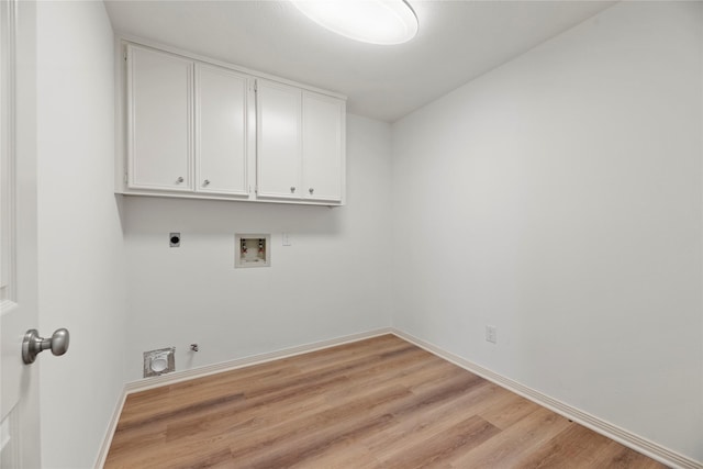 laundry area featuring cabinets, washer hookup, hookup for an electric dryer, hookup for a gas dryer, and light hardwood / wood-style floors