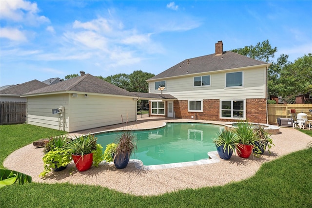 view of swimming pool with a lawn and a patio