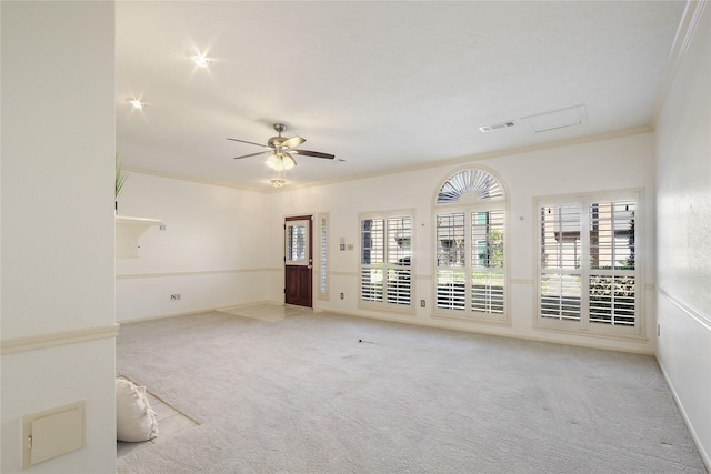 unfurnished room featuring crown molding, ceiling fan, and light colored carpet