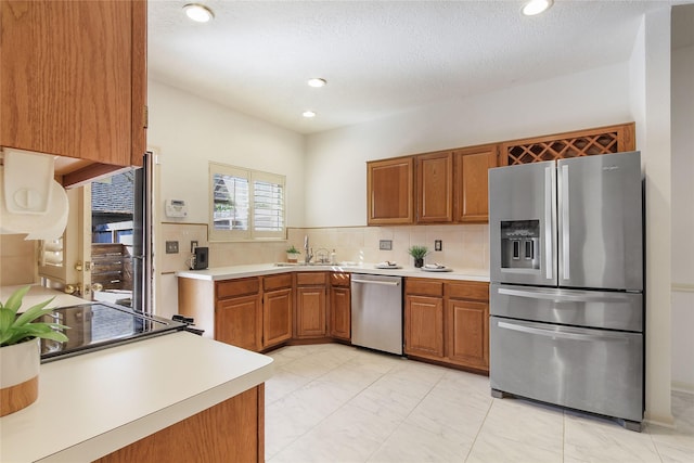 kitchen with backsplash, sink, and stainless steel appliances