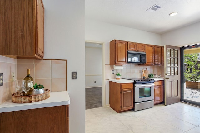 kitchen with backsplash and stainless steel range