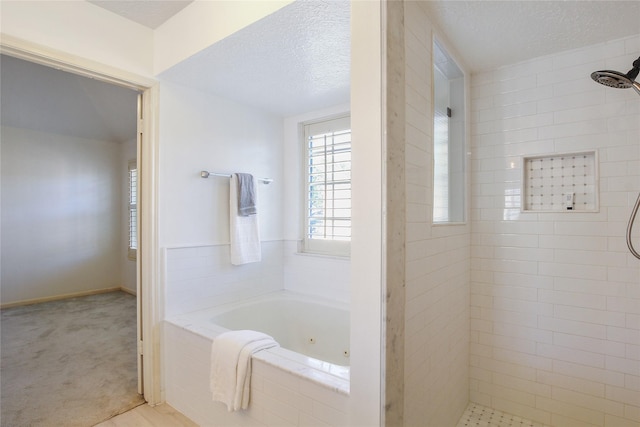 bathroom with plus walk in shower and a textured ceiling