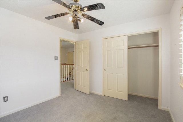 unfurnished bedroom featuring ceiling fan, light carpet, and a closet