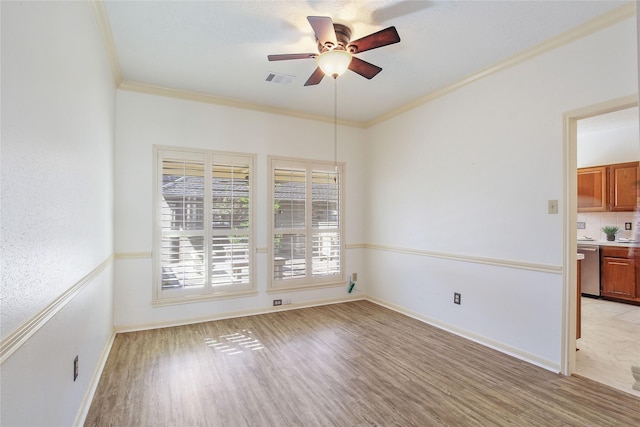 unfurnished room featuring ceiling fan, light hardwood / wood-style flooring, and ornamental molding